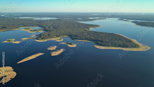 Aerial view Seliger lake in Ostashkovsky District of Tver Oblast Russia near Novgorod Oblast and Valdai Hills part of Volga basin. Summer sunny day. Dawn on beautiful Lake Seliger. Recreation and tour photo