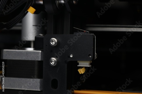 3D printer parts close-up of limit switch and Stepper motor responsible for axis movements while 3 dimensional printing process