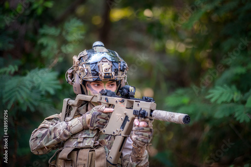 Female soldier is ready for fighting with gun. War, soldier army, gun and hostage rescue concept. photo