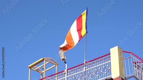 Slow motion shot of Colorful Buddhist Tibetan prayer flag against the blue sky at Pangan Nyingma Monastery in Patlikuhal village near Manali, Himachal Pradesh, India	