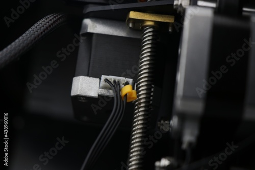 3D Printer parts closeup of Filament feeding stepper motor or extruder motor with threaded rod