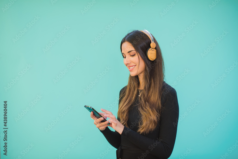 Smiling woman in headset chatting on smartphone Smiling woman in headset chatting on smartphone