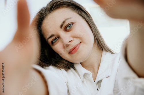 Close-up shot of happy young woman, wears white clothing. Lifestyle concept.