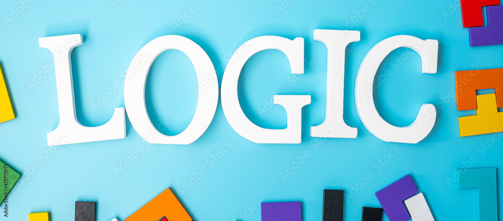 LOGIC text with colorful wood puzzle pieces, geometric shape block on blue background. Concepts of logical thinking, Conundrum, solutions, rational, strategy, world logic day and Education