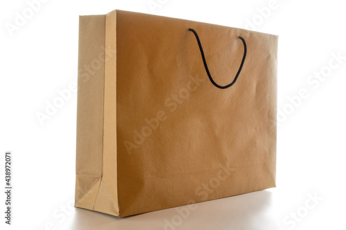 Old paper bag. Brown package with kraft recycle texture, empty blank space for design mockup isolated on white background. Delivery service concept. Copy space. Advertising area.
