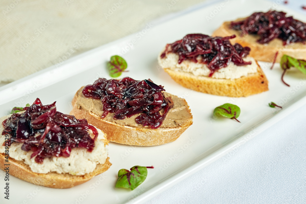 bruschetta with seaweed on a white plate on a light background bruschetta with seaweed on a white plate on a light background