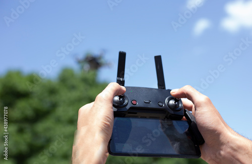 man controls the drone using the remote control. Close-up photo.