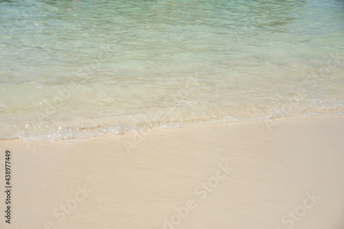 beautiful soft wave on sand at the sea sunny day. subject is blurred. © suparat1983