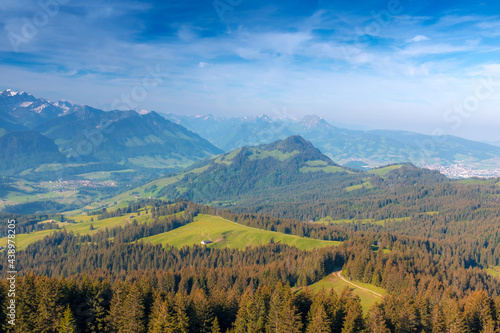 Panoramic landscape view of the Swiss Alpes,with blue sky in the background, shot in La Berra, Gruyère, Switzerland