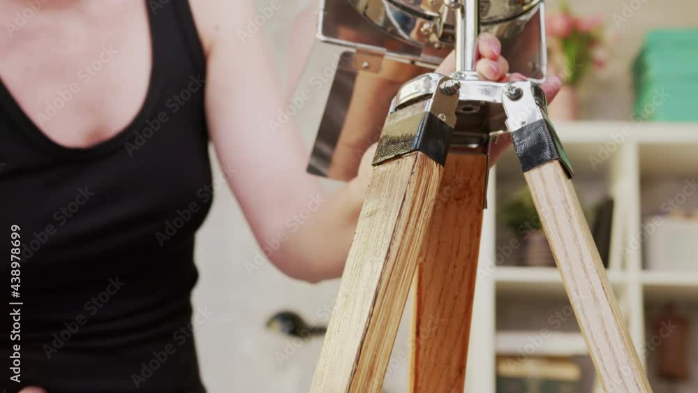 DIY - Do It Yourself. Young woman renovating and painting a design lamp at home. Renewing, tinkering, home improvement. DIY - Do It Yourself. Young woman renovating and painting a design lamp at home. Renewing, tinkering, home improvement.