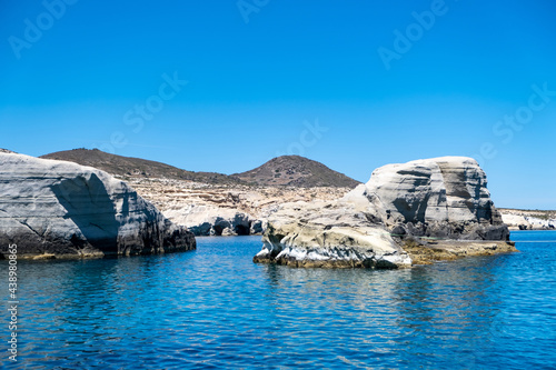 Fototapeta Naklejka Na Ścianę i Meble -  Sarakiniko beach at Milos island, Cyclades Greece. White rock formations, cliffs and caves over blue sea