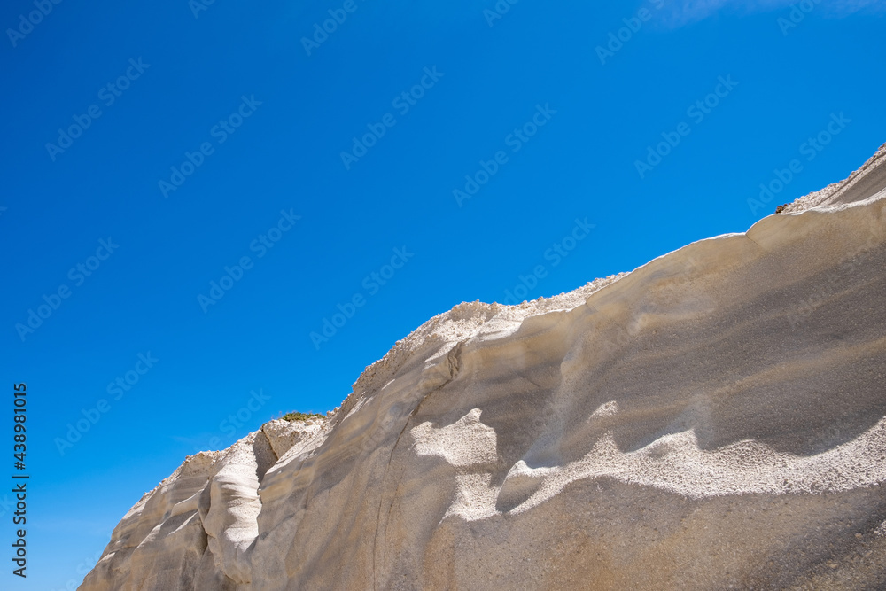 Lunar landscape at Sarakiniko beach, Milos island, Cyclades Greece, Abstract natural rock shapes. White stone formation, blue sky backgroynd.