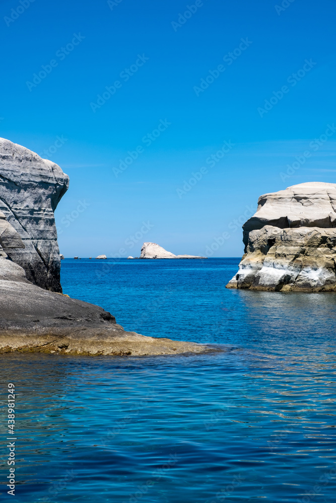 Sarakiniko beach at Milos island, Cyclades Greece. White rock formations, cliffs and caves over blue sea