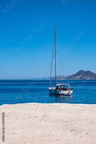 Sarakiniko beach at Milos island, Cyclades Greece. Sail boat moored on blue sea