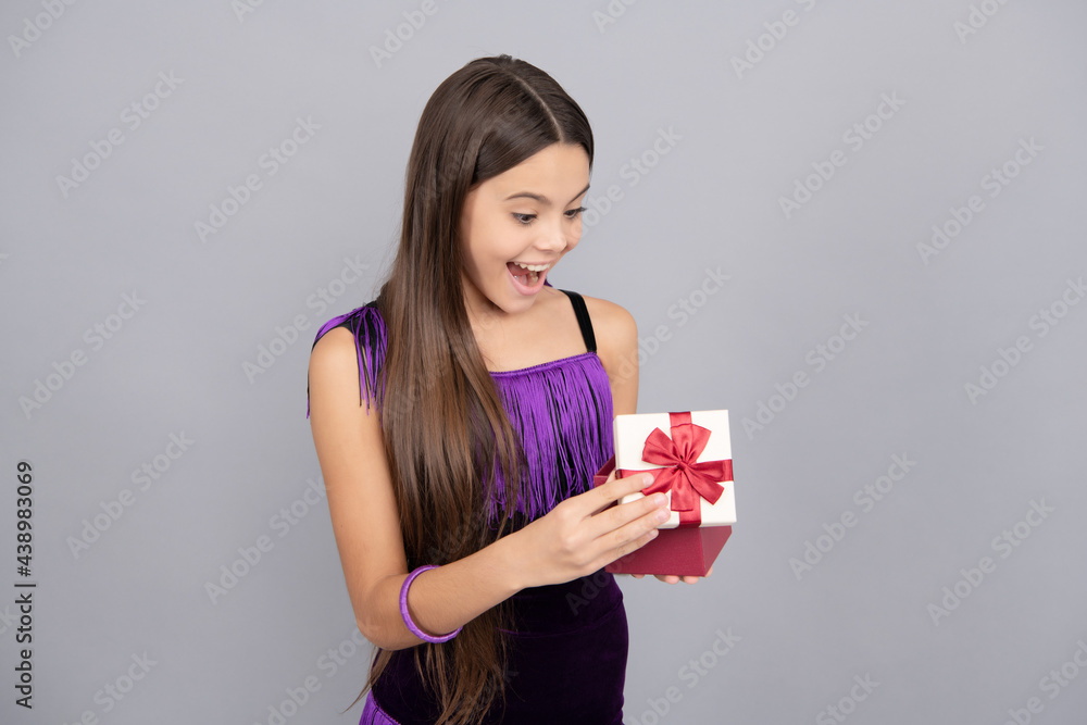 Surprised kid open wrapped present box grey background, surprise Surprised kid open wrapped present box grey background, surprise