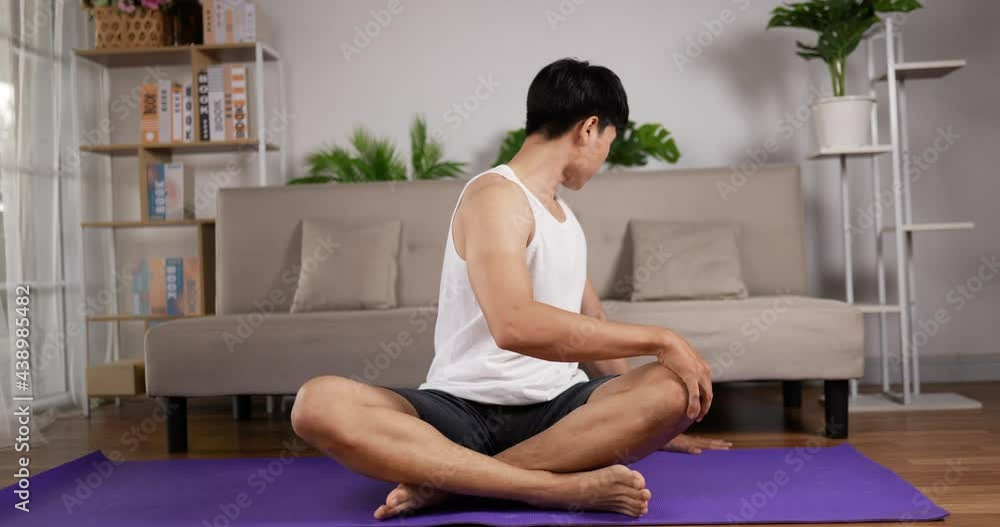 man sitting on floor and stretching man sitting on floor and stretching