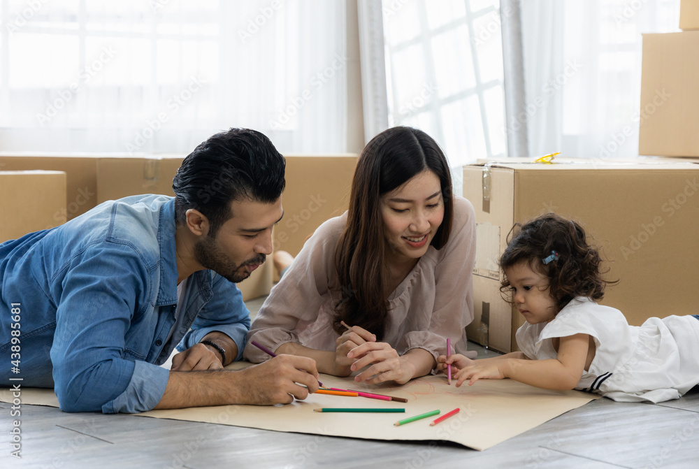 Father Mother and daughter drawing and coloring with colored pencils lying down on the floor. Happy family moment in the house.Art Activity in kindergarten. Father Mother and daughter drawing and coloring with colored pencils lying down on the floor. Happy family moment in the house.Art Activity in kindergarten.