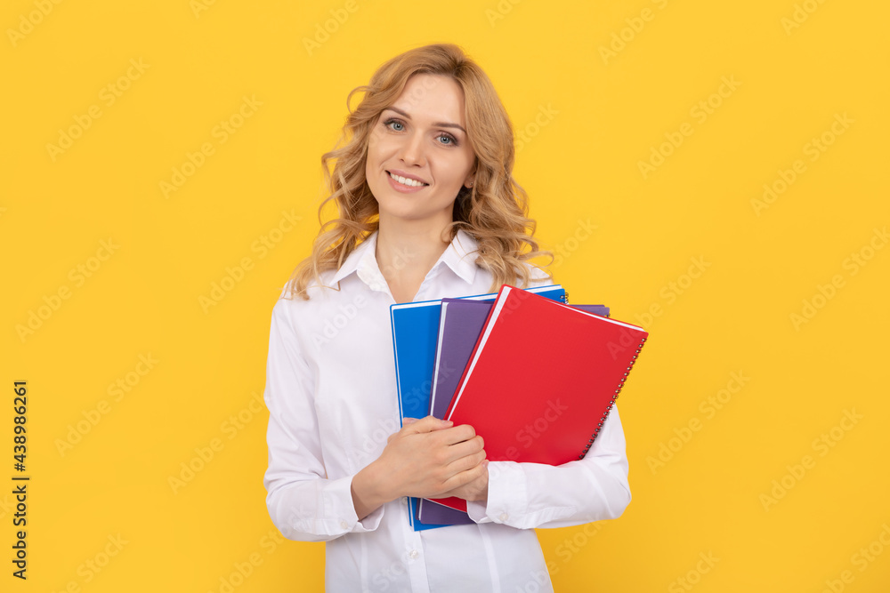 happy blonde businesswoman woman in white shirt hold notepad or notebook, teacher happy blonde businesswoman woman in white shirt hold notepad or notebook, teacher