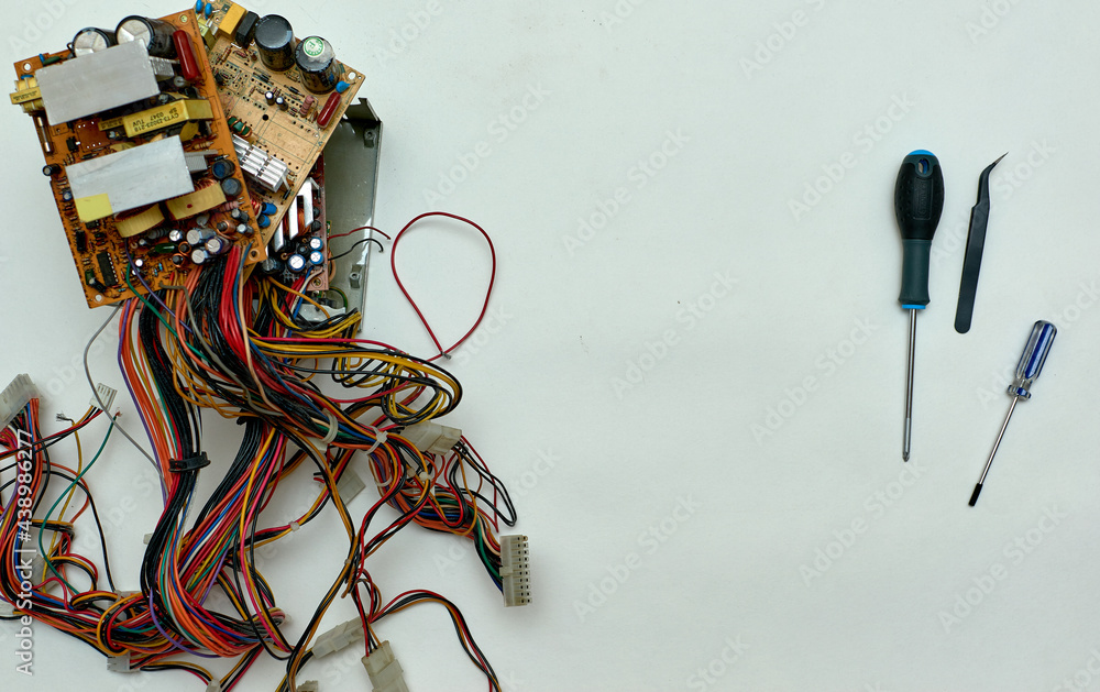 Disassembled power supply of a stationary personal computer on an isolated background. Repair of computer equipment.
