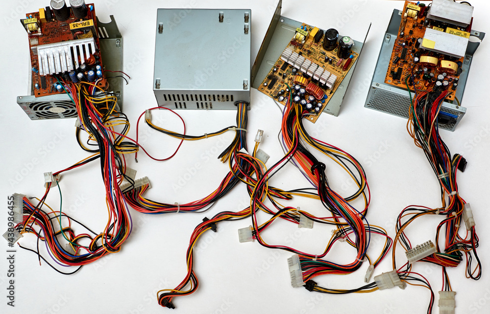 Disassembled power supply of a stationary personal computer on an isolated background. Repair of computer equipment.