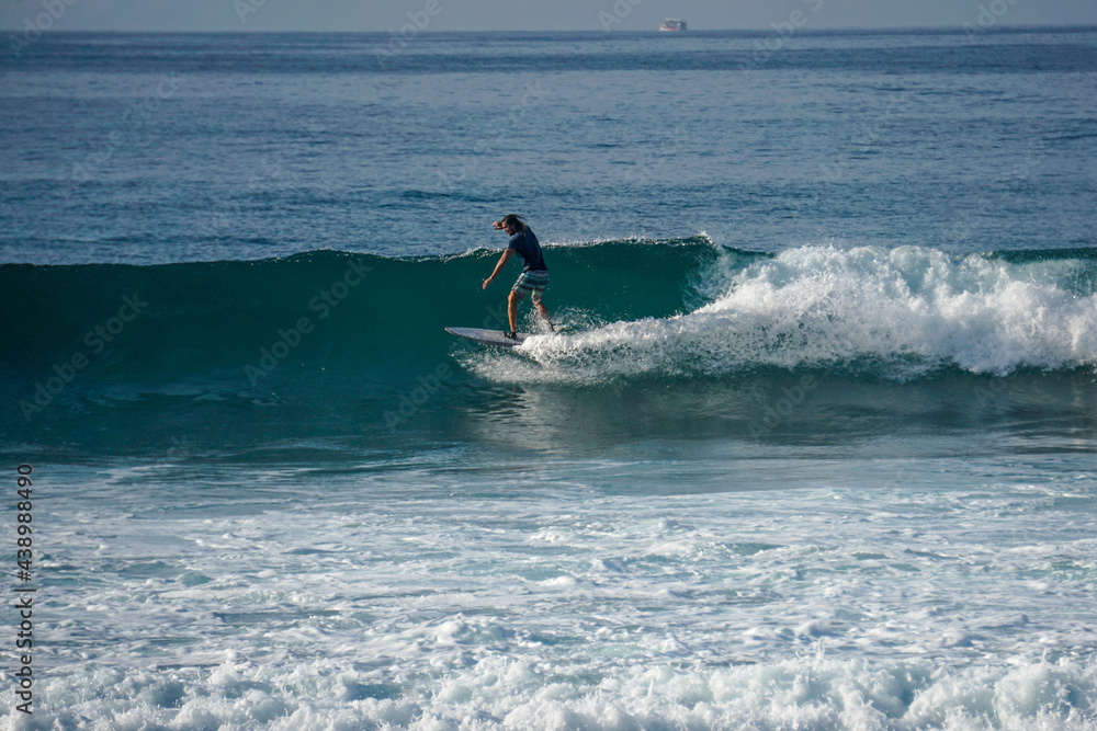 Surfer on perfect blue aquamarine wave, empty line up, perfect for surfing, clean water, Indian Ocean close to Mirissa Surfer on perfect blue aquamarine wave, empty line up, perfect for surfing, clean water, Indian Ocean close to Mirissa
