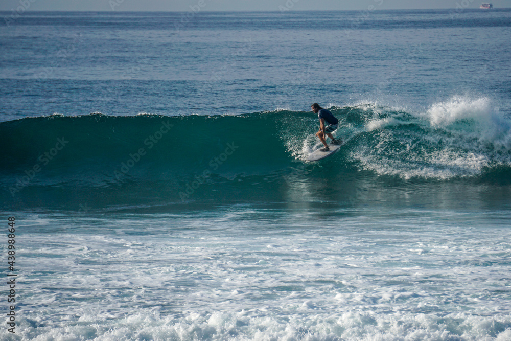 Surfer on perfect blue aquamarine wave, empty line up, perfect for surfing, clean water, Indian Ocean close to Mirissa Surfer on perfect blue aquamarine wave, empty line up, perfect for surfing, clean water, Indian Ocean close to Mirissa
