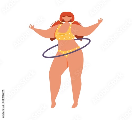 A young woman in a yellow swimsuit spins a hula hoop.