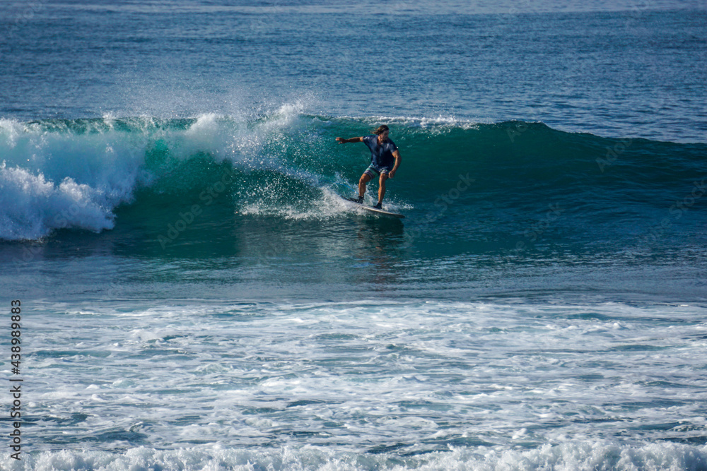 Surfer on perfect blue aquamarine wave, empty line up, perfect for surfing, clean water, Indian Ocean close to Mirissa Surfer on perfect blue aquamarine wave, empty line up, perfect for surfing, clean water, Indian Ocean close to Mirissa