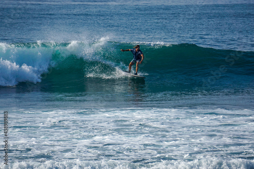 Surfer on perfect blue aquamarine wave, empty line up, perfect for surfing, clean water, Indian Ocean close to Mirissa