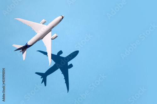 Model plane, airplane on sky blue background with deep shadow © vetre