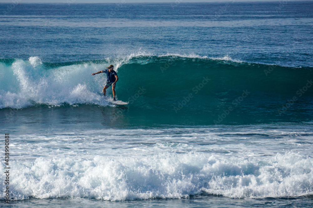 Surfer on perfect blue aquamarine wave, empty line up, perfect for surfing, clean water, Indian Ocean close to Mirissa Surfer on perfect blue aquamarine wave, empty line up, perfect for surfing, clean water, Indian Ocean close to Mirissa