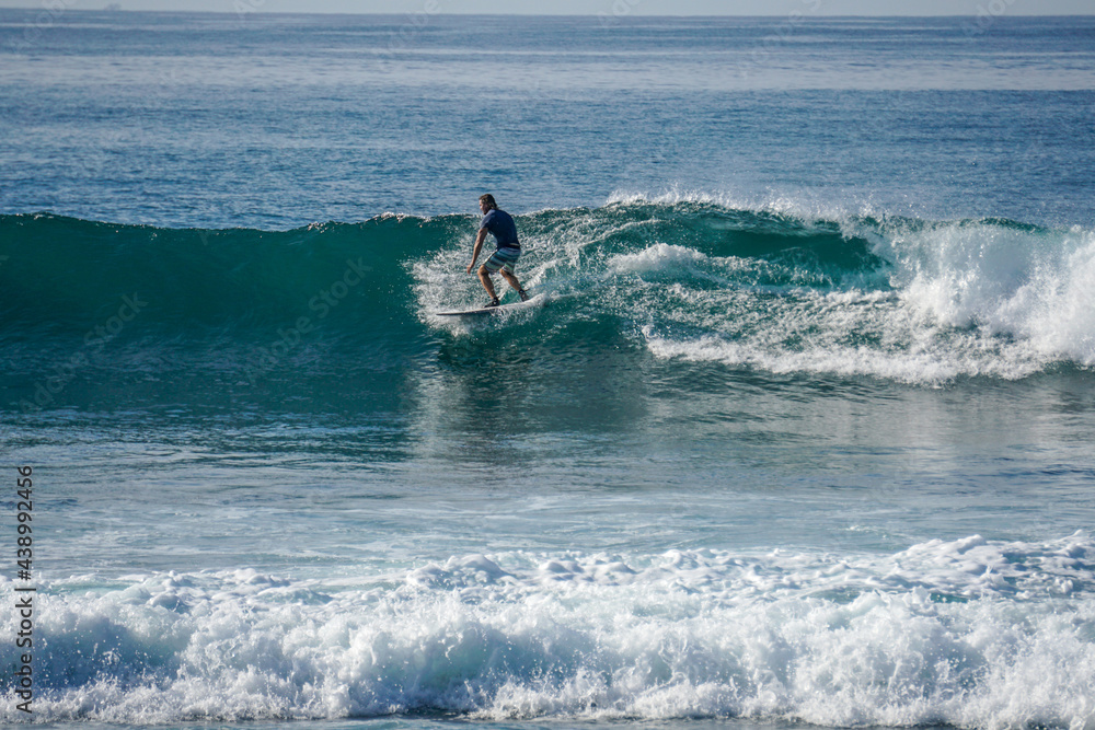 Surfer on perfect blue aquamarine wave, empty line up, perfect for surfing, clean water, Indian Ocean close to Mirissa Surfer on perfect blue aquamarine wave, empty line up, perfect for surfing, clean water, Indian Ocean close to Mirissa