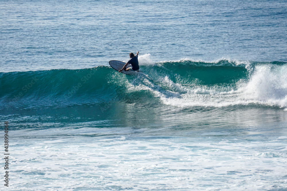 Surfer on perfect blue aquamarine wave, empty line up, perfect for surfing, clean water, Indian Ocean close to Mirissa Surfer on perfect blue aquamarine wave, empty line up, perfect for surfing, clean water, Indian Ocean close to Mirissa