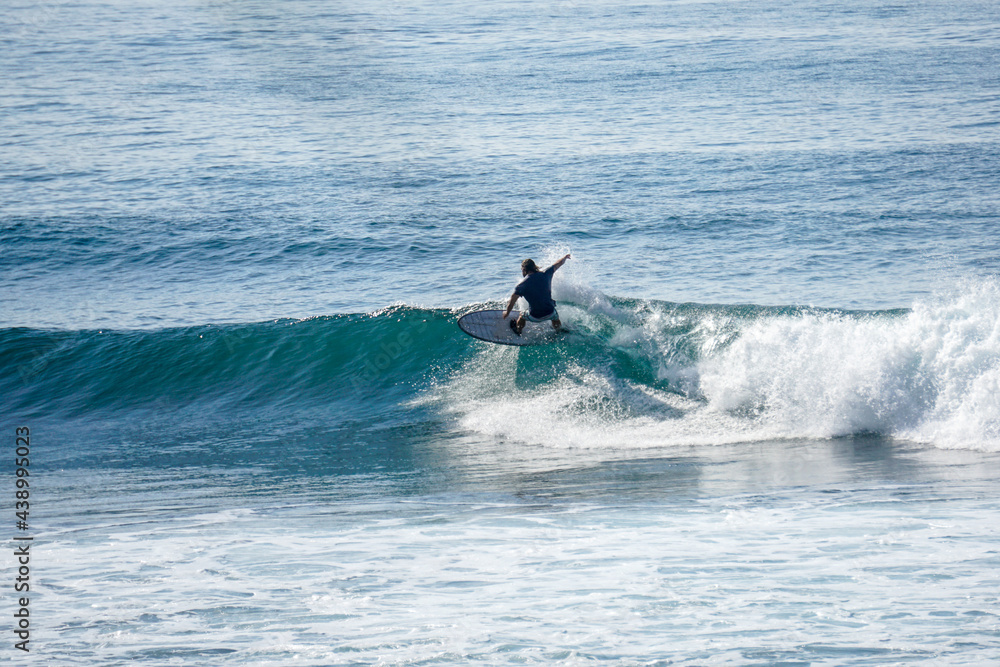 Surfer on perfect blue aquamarine wave, empty line up, perfect for surfing, clean water, Indian Ocean close to Mirissa Surfer on perfect blue aquamarine wave, empty line up, perfect for surfing, clean water, Indian Ocean close to Mirissa