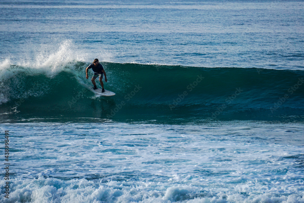 Surfer on perfect blue aquamarine wave, empty line up, perfect for surfing, clean water, Indian Ocean close to Mirissa Surfer on perfect blue aquamarine wave, empty line up, perfect for surfing, clean water, Indian Ocean close to Mirissa