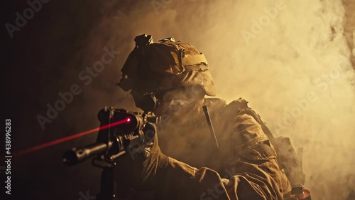 US marine soldier aiming with rifle at night in darkness