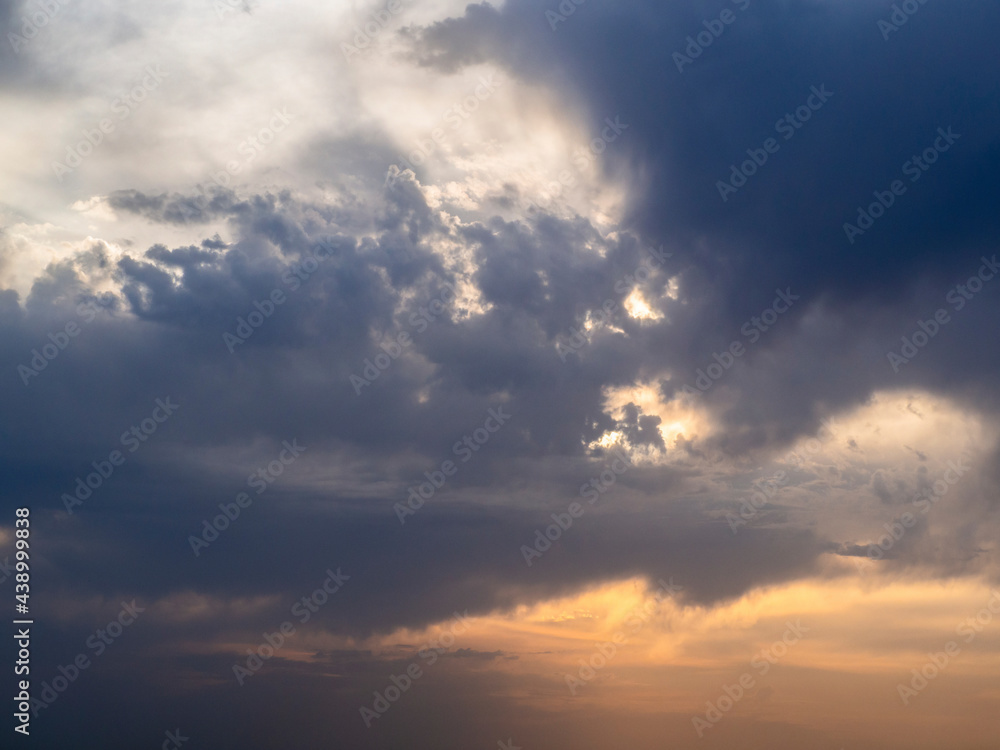 Sunset sky for background. Sun rays in colorful clouds