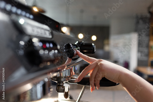 A barista prepares a professional coffee machine for work in a restaurant or cafe. The process of preparing the coffee machine for the preparation of espresso coffee.