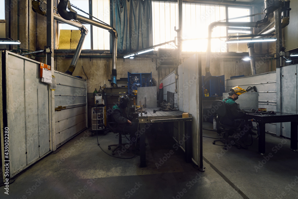 Metal industry worker working in factory, wearing protective face mask during coronavirus or covid19 pandemic. Metal industry worker working in factory, wearing protective face mask during coronavirus or covid19 pandemic.