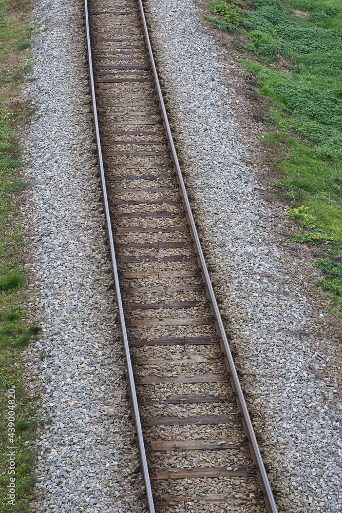 Railway bed. Fragment of railway tracks, top view, rails and sleepers.