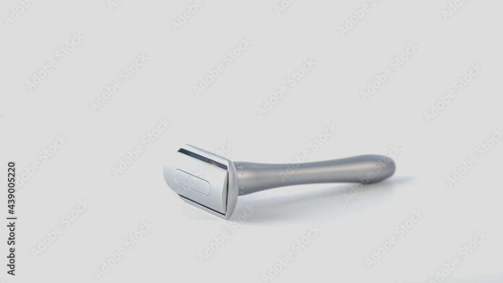 Metallic safety razor isolated on white background, close view Metallic safety razor isolated on white background, close view