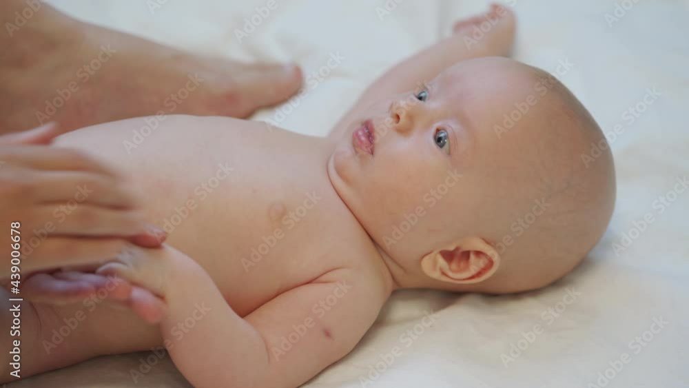 Mother massage 3 months old baby boy gently ppressing, rubbing parts of infant body, relax baby. High quality 4k footage Mother massage 3 months old baby boy gently ppressing, rubbing parts of infant body, relax baby. High quality 4k footage