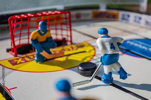 Table hockey. Players dressed in yellow and white.