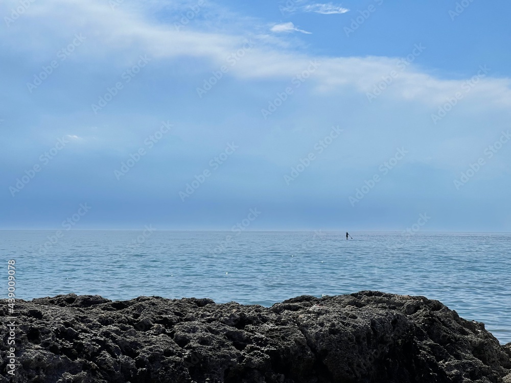 Man riding a Sup alone in the sea