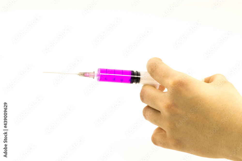 Hand holding syringe isolated Hand holding syringe isolated