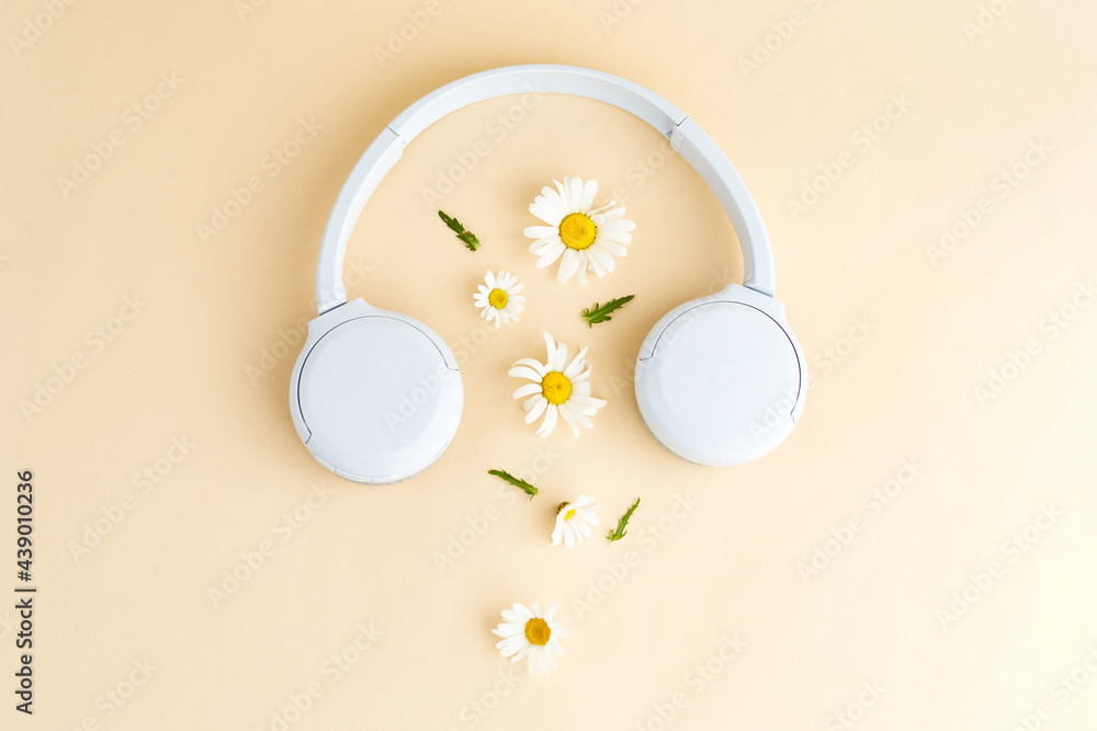 Music or podcast background with headphones and daisy (camomile) flowers on  yellow background. Summer podcast. Top view, flat lay Stock Photo | Adobe  Stock
