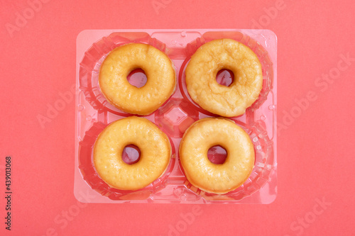 Donut box with sugar on pink background  breakfast with donuts