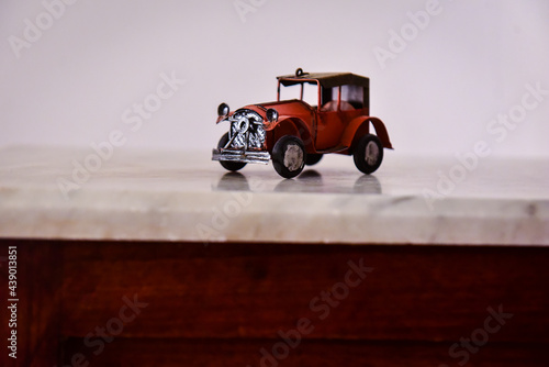 miniature old car with hood 