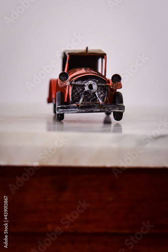 miniature old car with hood 