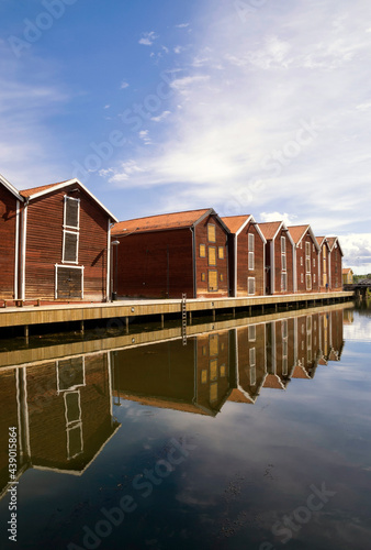 Wooden houses reflecting in the harbour in Hudiksvall © jstuij